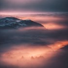 Serene Misty Landscape with Rolling Hills and Twilight Sky