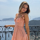 Elegant Woman in Pink Dress Overlooking Ocean View