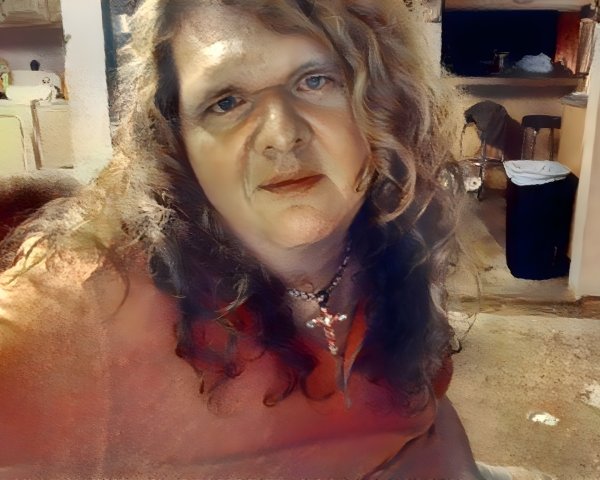 Thoughtful Woman in Coral Top in Dimly Lit Room
