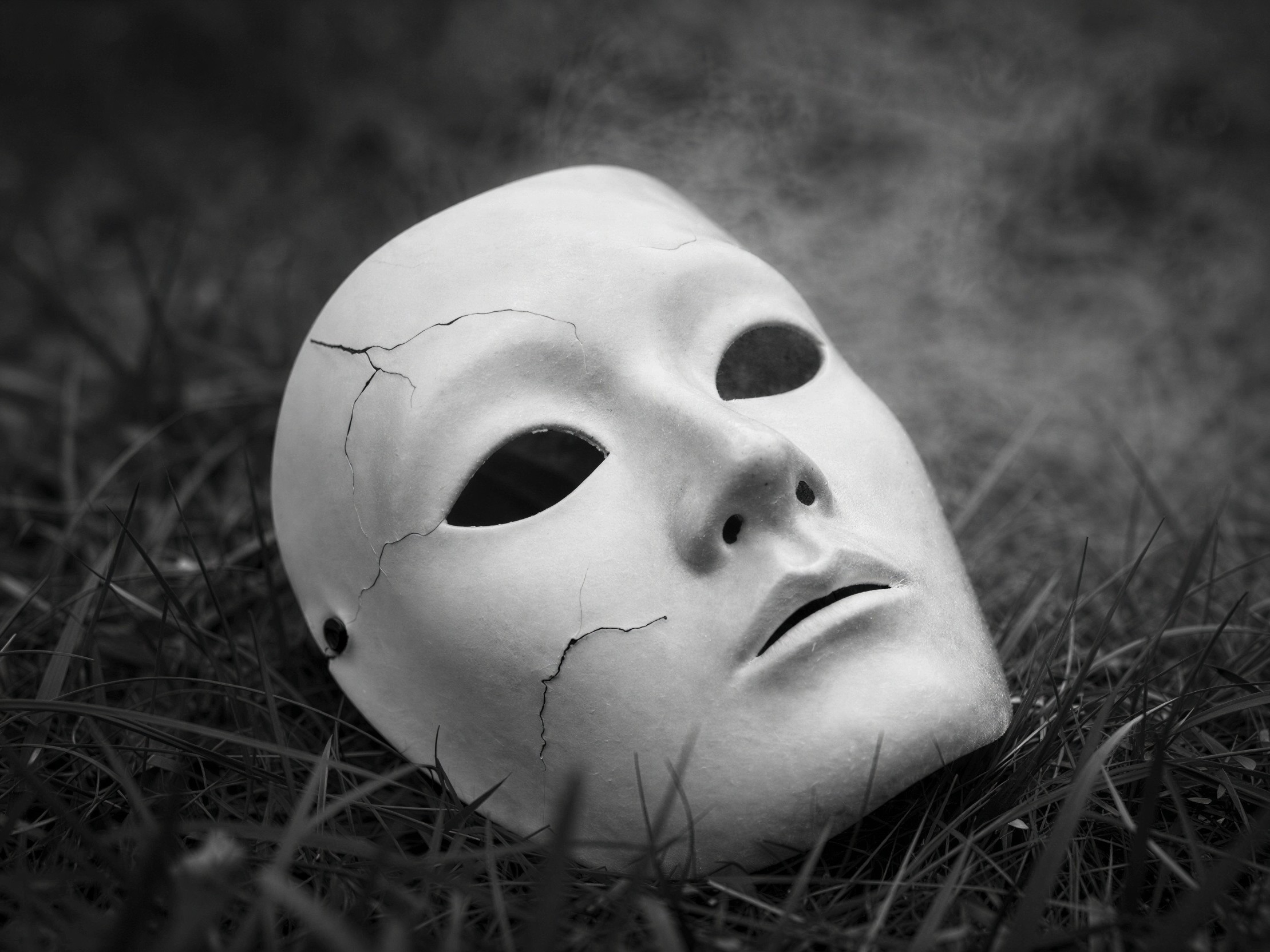 Black and White Close-Up of a Cracked Theatrical Mask