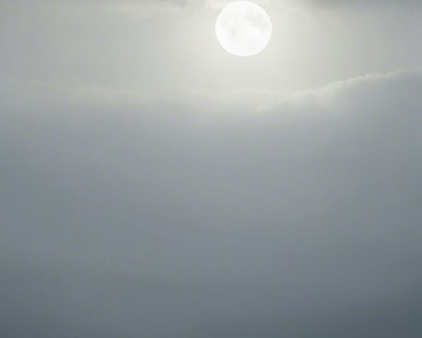 Cloaked Figure on Mountain Under Supermoon at Dusk