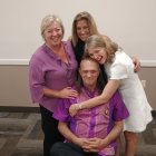 Group of Four Outdoors with Award and Cross Background