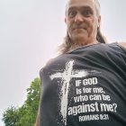 Mystical figure with glowing flames in serene landscape