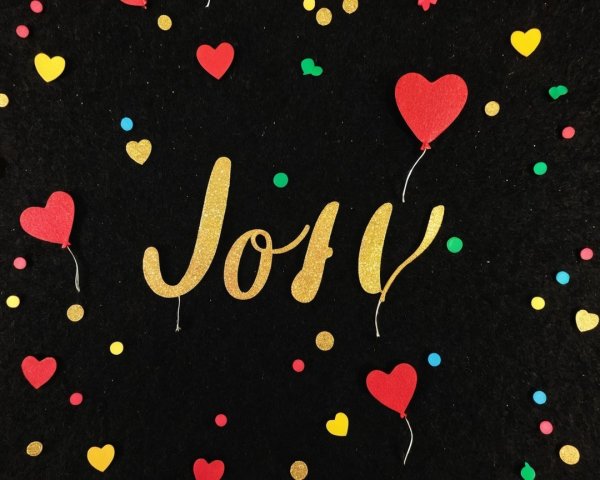 Colorful Confetti and Glittery "Joy" on Black Background