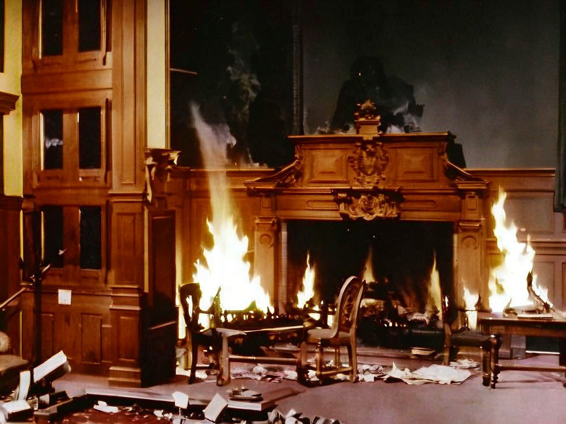 Room in Flames with Charred Books and Furniture