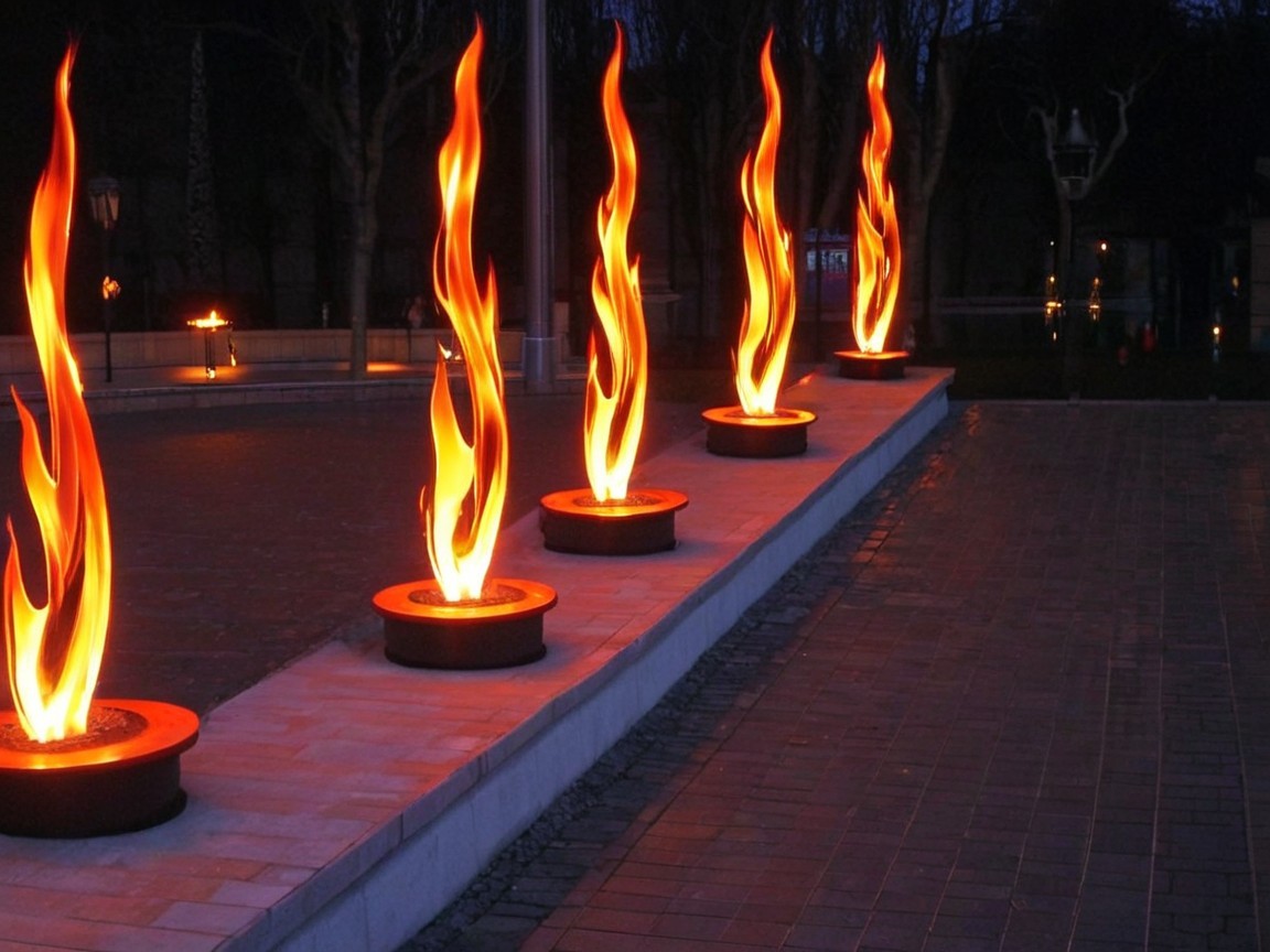 Flaming Sculptures Illuminate Twilight Pathway