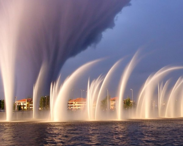 Dramatic Waterspout and Elegant Fountains Contrast