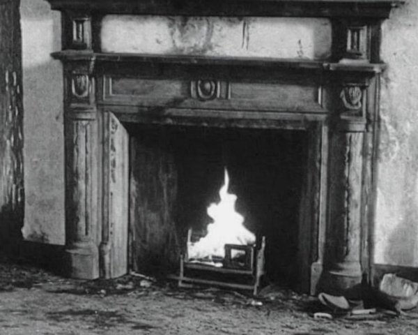 Vintage Fireplace with Ornate Wooden Mantel and Fire