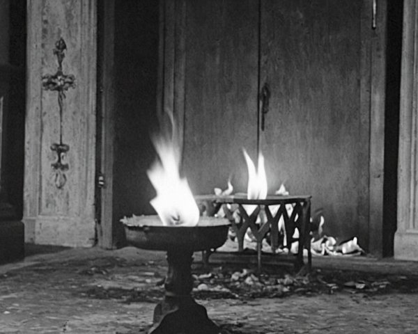 Dimly Lit Interior with Flickering Flame and Shadows