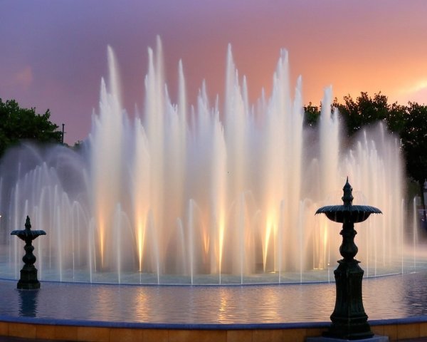 Majestic Fountain with Water Jets and Sunset Reflection