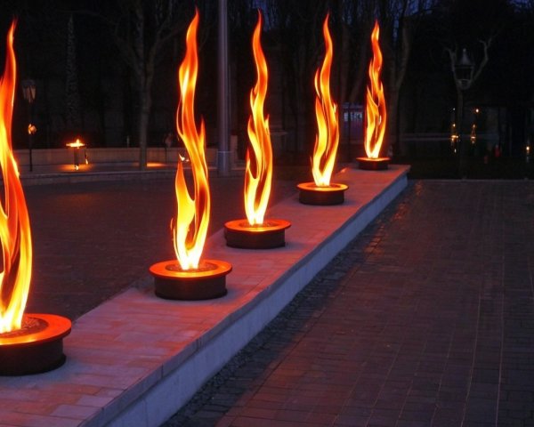 Flaming Sculptures Illuminate Twilight Pathway