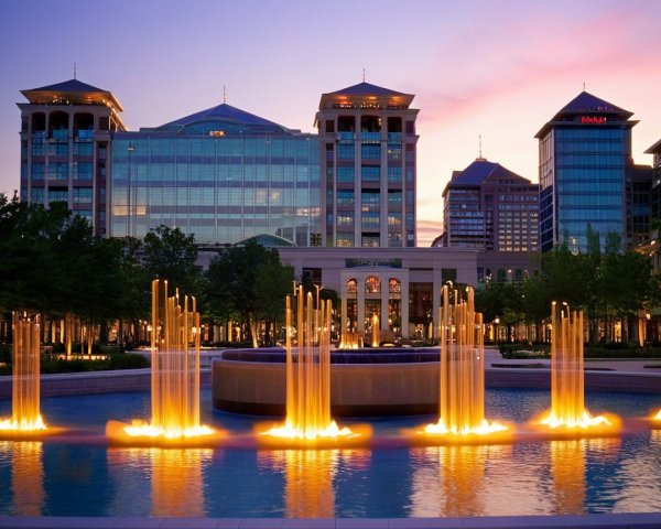 Modern urban plaza with fountain and glass buildings