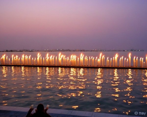 Twilight Scene with Candles by the Water's Edge