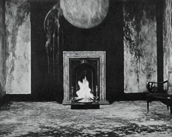 Dimly Lit Room with Glowing Orb and Fireplace