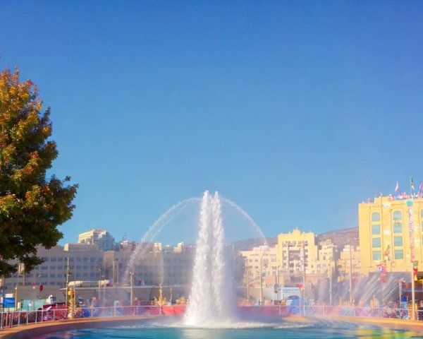 Vibrant Urban Scene with Central Fountain and Walkways
