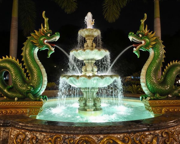 Vibrant Green Dragon Statues by Ornate Fountain
