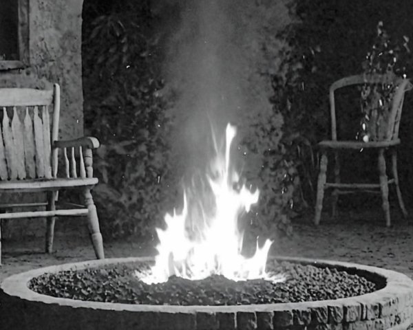 Cozy Outdoor Scene with Stone Fire Pit and Chairs