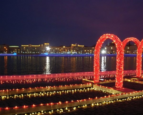 Serene Riverside Scene with Colorful Lights and Arches