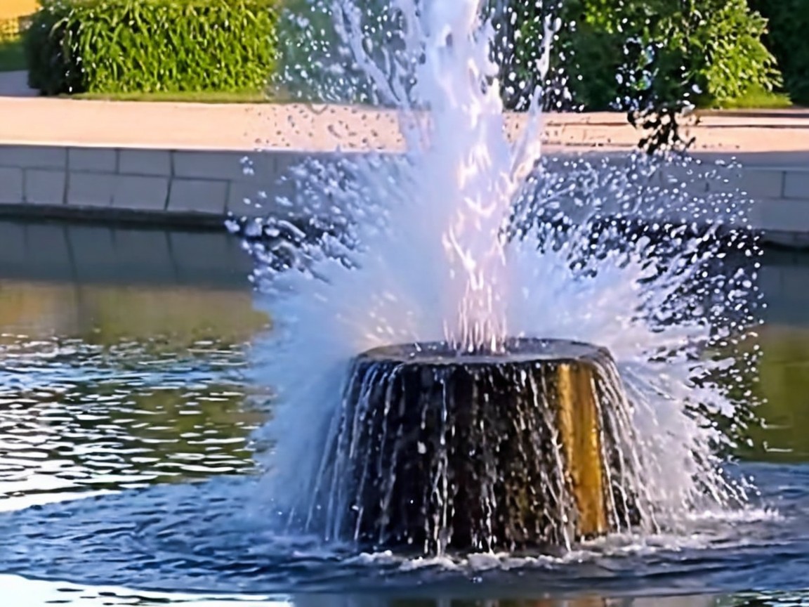 Stone Fountain in Tranquil Pond Surrounded by Greenery