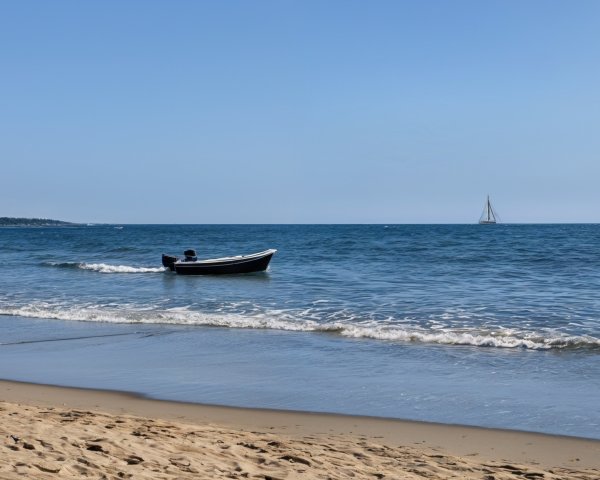Serene beach scene with boats and clear blue water