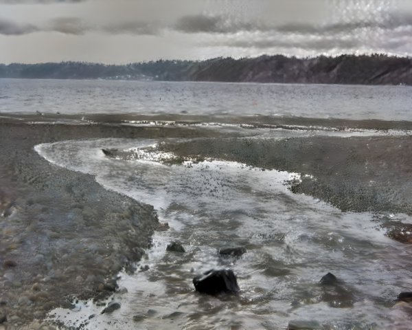 Tranquil Coastal Scene with Stream and Misty Hills
