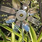 Surreal Flower Composition with Metallic Cutlery Elements