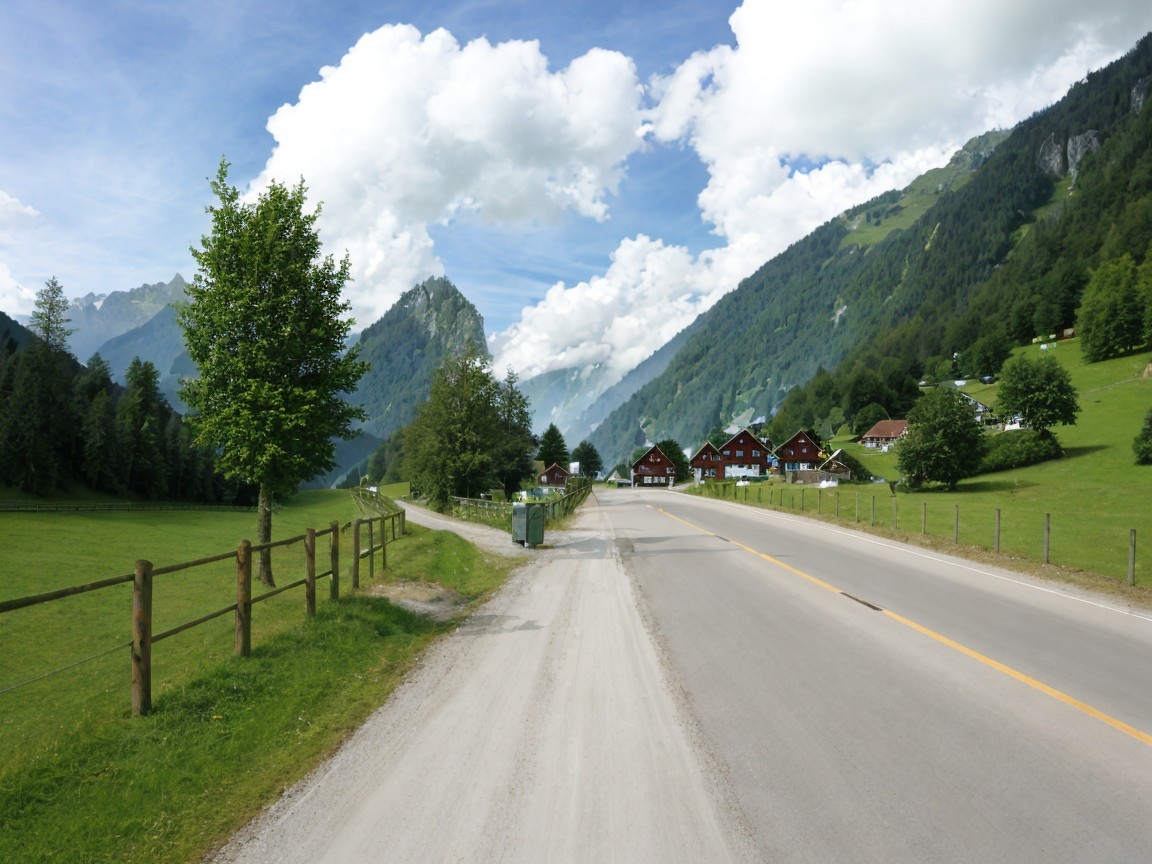Scenic Landscape with Road, Fence, and Traditional Houses