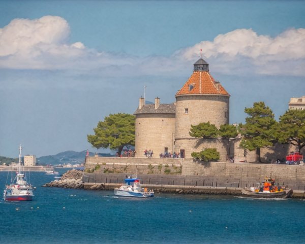 Scenic Coastal View with Historic Stone Tower and Boats