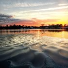 Tranquil Sunset Reflection with Blue Lotus Flowers