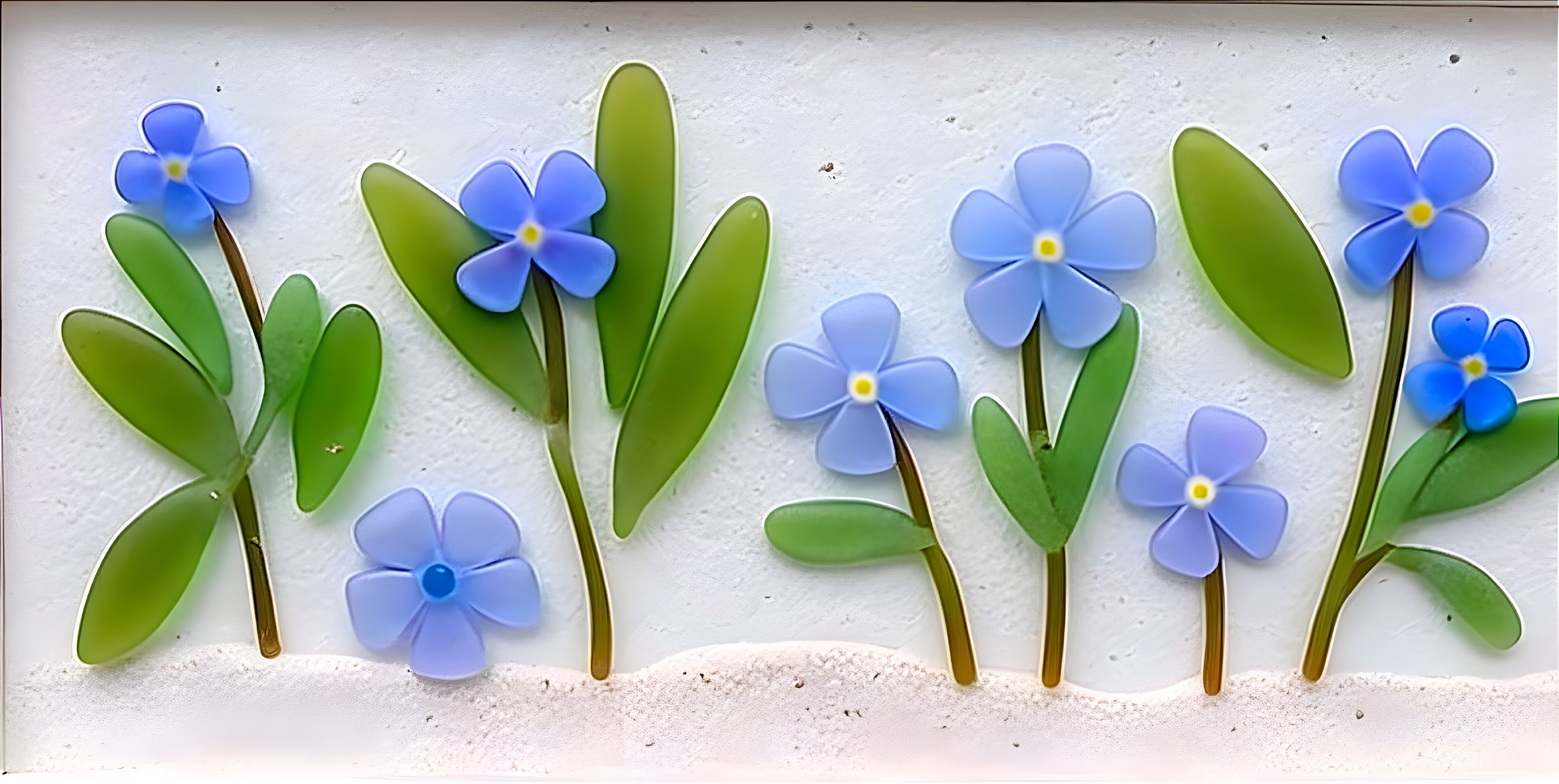 Delicate Blue Flowers with Green Leaves on Sandy Background