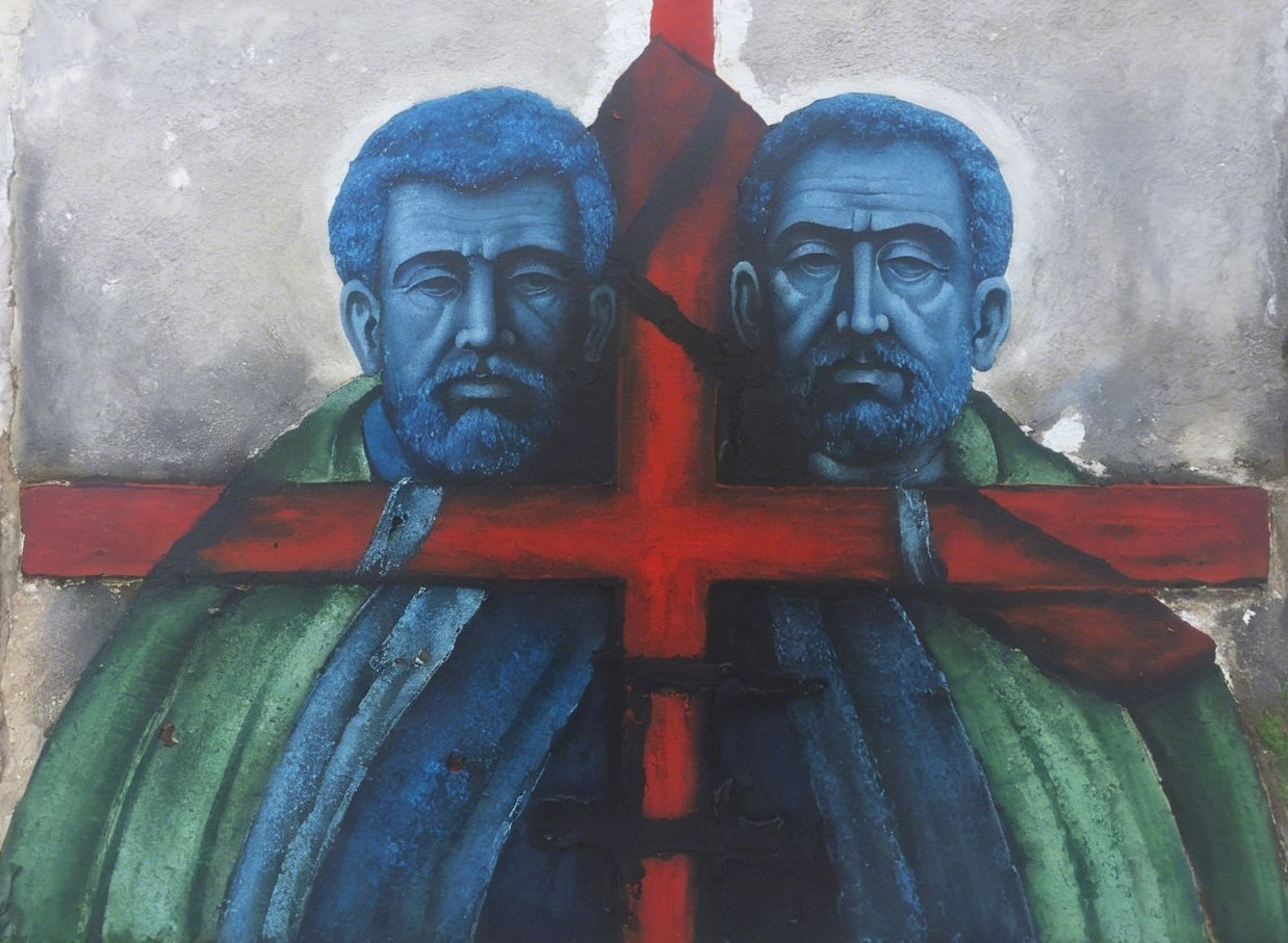 Mural of Two Male Figures with Blue Faces and Red Cross