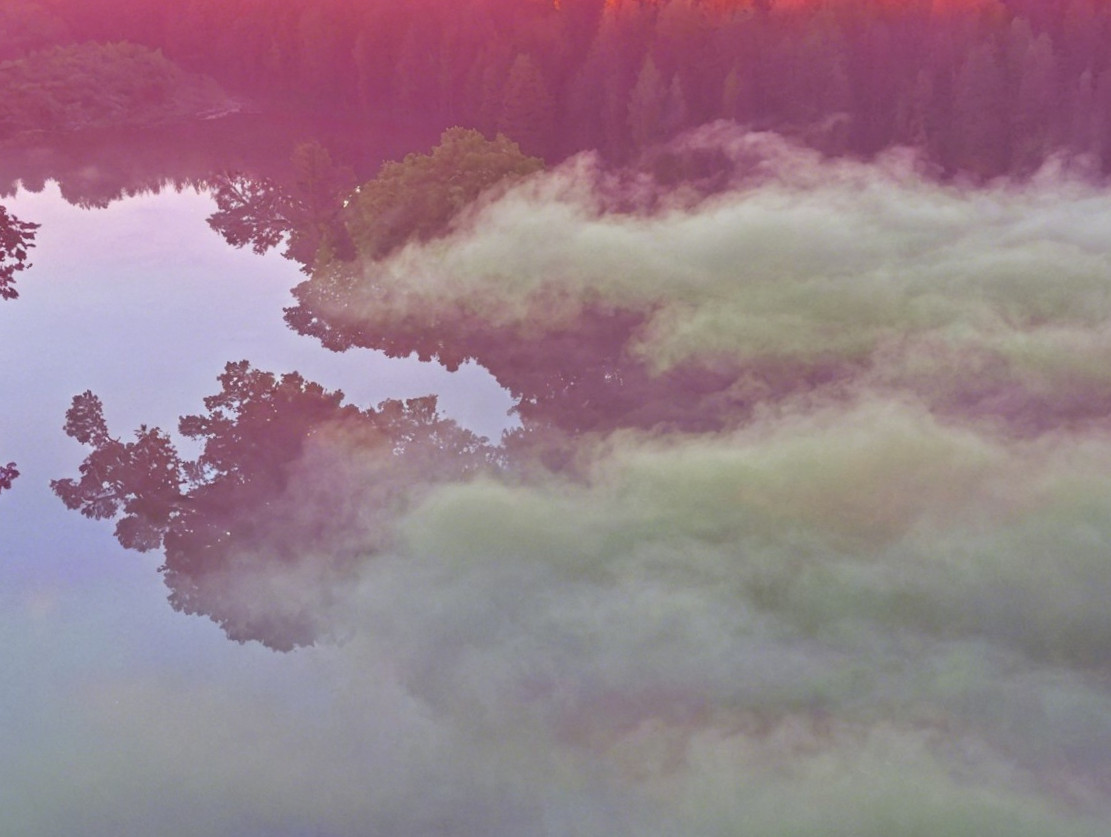 Serene Landscape with Reflective Water and Sunset Sky