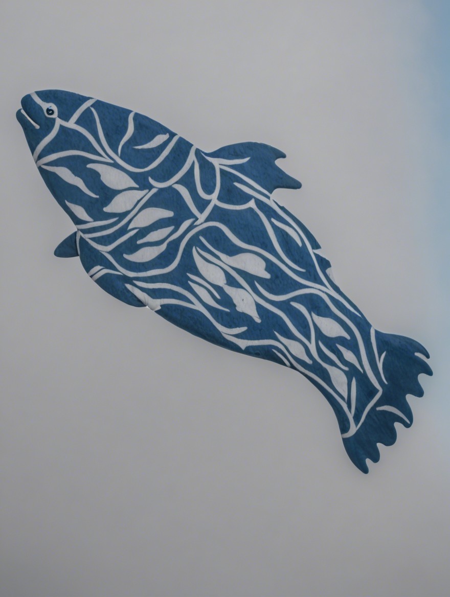 Wooden fish sculpture with white leaf patterns on blue