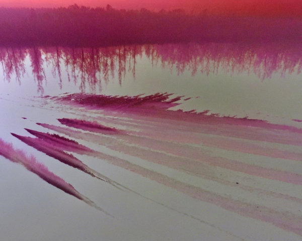 Serene Sunset Over Water with Vibrant Reflections