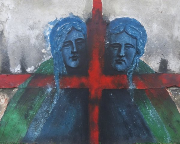 Mural of Two Serene Faces with Bold Colors