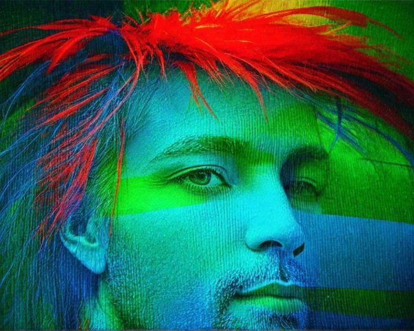 Person with vibrant spiky hair and contemplative expression