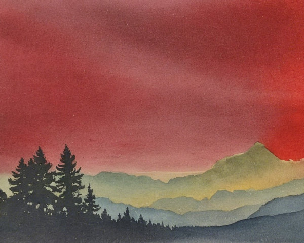 Vibrant Sunset Over Silhouetted Mountain Range