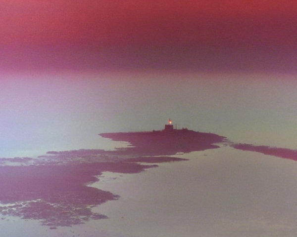 Lighthouse on Island Surrounded by Calm Waters