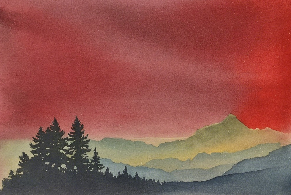 Vibrant Sunset Over Silhouetted Mountain Range