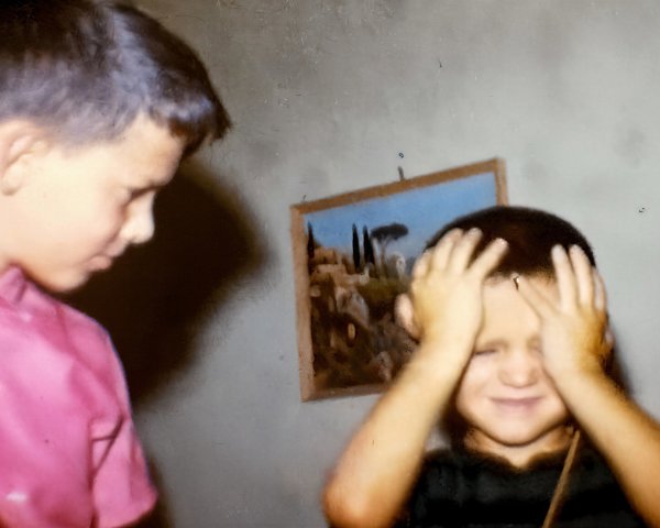 Close-Up of Two Boys Indoors with Framed Painting