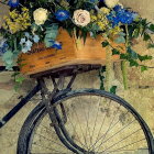 Vintage Bicycle with Flowers Against Stone Wall